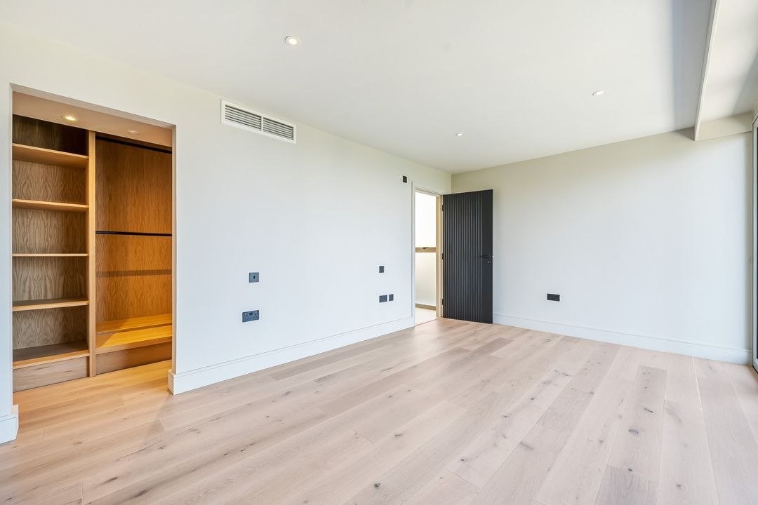 Fitted wardrobe and pale timber floor in a premium Cornwall bedroom